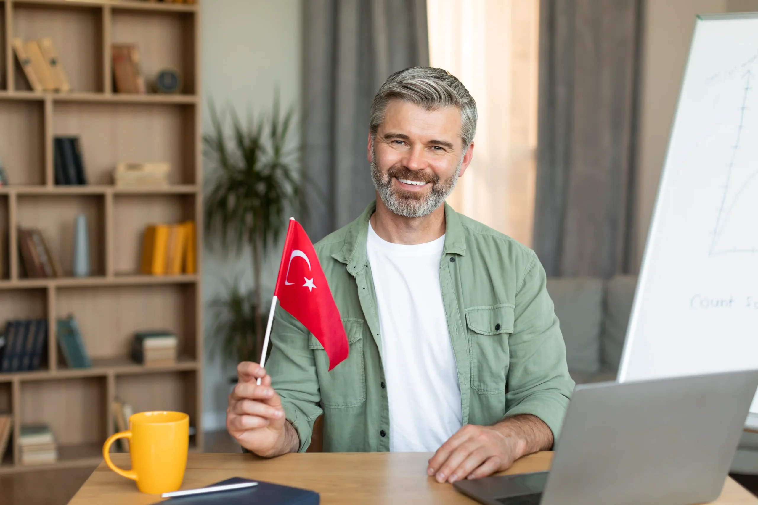 Elderly man smiling holding Turkey flag